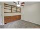 Cozy bedroom with carpet, a ceiling fan, and built-in shelving and cabinets at 6505 Kalua Rd # 104B, Boulder, CO 80301