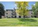 Multi-Gathering residential building with private balconies, mature landscaping, and a well-maintained lawn at 6505 Kalua Rd # 104B, Boulder, CO 80301