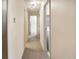 Long hallway with carpet and multiple doors, offering access to various rooms at 6505 Kalua Rd # 104B, Boulder, CO 80301