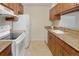 Functional kitchen featuring wood cabinets, white appliances, and granite countertops at 6505 Kalua Rd # 104B, Boulder, CO 80301