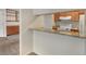 Bright kitchen features a breakfast bar, wooden cabinetry, white appliances, and granite countertops at 6505 Kalua Rd # 104B, Boulder, CO 80301