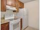 Functional kitchen with white appliances and wood cabinets at 6505 Kalua Rd # 104B, Boulder, CO 80301