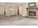 Bright living room featuring a stone fireplace and a kitchen view at 6505 Kalua Rd # 104B, Boulder, CO 80301