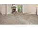 Spacious living room with a stone fireplace, sliding glass doors and plush carpeting at 6505 Kalua Rd # 104B, Boulder, CO 80301