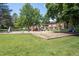 Community playground with slides, climbing structures, and mature trees at 6505 Kalua Rd # 104B, Boulder, CO 80301