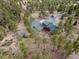 Secluded home on large lot surrounded by mature trees, featuring a garden, outbuildings and circular driveway at 13660 Rampart Dr, Conifer, CO 80433