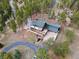 Beautiful house featuring multiple decks, surrounded by dense trees and including a driveway and lush landscaping at 13660 Rampart Dr, Conifer, CO 80433