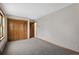 Bedroom showcasing closet, neutral walls, and plush carpeting at 13660 Rampart Dr, Conifer, CO 80433