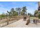 Outdoor deck with a pond, lush landscaping, and views of the trees, showcasing a serene outdoor space at 13660 Rampart Dr, Conifer, CO 80433
