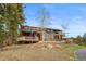 Attractive exterior featuring multiple decks, natural landscaping, and charming stone accents, enhancing its curb appeal at 13660 Rampart Dr, Conifer, CO 80433