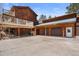 Exterior view of the house with a driveway leading to a two-car garage, highlighting outdoor living spaces at 13660 Rampart Dr, Conifer, CO 80433