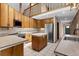 Kitchen featuring wood cabinets, an island, stainless steel appliances and views of a loft above at 13660 Rampart Dr, Conifer, CO 80433