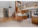 Eat-in kitchen with an island, wood cabinets, and views into the living room with fireplace and loft above at 13660 Rampart Dr, Conifer, CO 80433