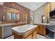 Charming kitchen with brick accent wall, wooden cabinets, and stainless-steel appliances at 13660 Rampart Dr, Conifer, CO 80433