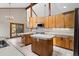 Bright kitchen featuring wood cabinets, stainless appliances, and an island with a light countertop at 13660 Rampart Dr, Conifer, CO 80433