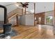 Cozy living area with a staircase, wood-burning fireplace and brick accent wall leading to the kitchen at 13660 Rampart Dr, Conifer, CO 80433
