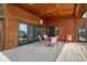 Covered patio with a dining set and views of surrounding nature, perfect for outdoor entertaining at 13660 Rampart Dr, Conifer, CO 80433