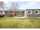 This lush backyard features a patio set on a green lawn at 815 S Jersey St, Denver, CO 80224