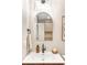 Bathroom featuring an oval mirror over the sink with unique sconces and modern fixtures at 815 S Jersey St, Denver, CO 80224