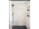Modern shower featuring light tile walls, black fixtures, and stylish storage nooks at 815 S Jersey St, Denver, CO 80224