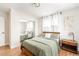 Cozy bedroom with wood floors, sage bedding, and a mirrored closet for an open, airy feel at 815 S Jersey St, Denver, CO 80224