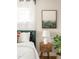Close-up showcasing a nightstand with lamp, art, and leafy decor in the bedroom at 815 S Jersey St, Denver, CO 80224