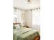 Bright bedroom with natural light, sheer curtains, hardwood floors, and minimalist decor at 815 S Jersey St, Denver, CO 80224