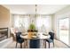 Welcoming dining room featuring a gas fireplace, hardwood floors and lots of natural light at 815 S Jersey St, Denver, CO 80224