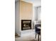 Stylish fireplace with modern mantle and trim and hearth with sleek chair and side table at 815 S Jersey St, Denver, CO 80224