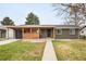 The home's updated exterior with a well-maintained lawn and inviting front entrance at 815 S Jersey St, Denver, CO 80224