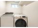 Bright laundry room with modern Samsung washer and dryer and a small window at 815 S Jersey St, Denver, CO 80224