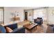 Open-concept living room area with modern furnishings, decor, and hardwood floors at 815 S Jersey St, Denver, CO 80224