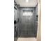 This modern shower is tiled in blue, and it features a shower head and a small window at 815 S Jersey St, Denver, CO 80224