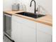 Wet bar includes a built-in sink, butcher block counter, beverage fridge and white cabinetry at 815 S Jersey St, Denver, CO 80224