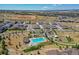 Aerial shot of community pool, playground, green space, and surrounding neighborhood at 12214 Stone Timber Ct, Parker, CO 80134