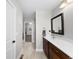 Bright bathroom with a long vanity, a large mirror, and an entrance to a closet at 12214 Stone Timber Ct, Parker, CO 80134
