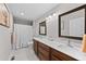 Spacious bathroom with double sink vanity, stylish mirrors, and a bathtub with tile surround at 12214 Stone Timber Ct, Parker, CO 80134