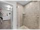 Modern bathroom featuring a glass shower door, tiled walls, and pebble-style flooring at 12214 Stone Timber Ct, Parker, CO 80134