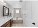 Elegant bathroom featuring double sinks, a soaking tub, and modern fixtures at 12214 Stone Timber Ct, Parker, CO 80134