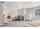 Open bedroom and bathroom with a neutral sofa and dresser at 12214 Stone Timber Ct, Parker, CO 80134