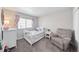 Cozy Bedroom with crib, comfortable armchair, and soft natural light at 12214 Stone Timber Ct, Parker, CO 80134