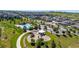 Aerial view of community with a pool, playground, and rows of townhomes in a suburban neighborhood at 12214 Stone Timber Ct, Parker, CO 80134