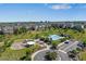 Aerial view of community pool, playground, and rows of townhomes in a suburban neighborhood at 12214 Stone Timber Ct, Parker, CO 80134