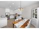 Bright dining area with white cabinets, stainless steel appliances, and farmhouse style table and chairs at 12214 Stone Timber Ct, Parker, CO 80134
