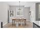 Bright dining room with a classic chandelier and white chairs, open to the kitchen at 12214 Stone Timber Ct, Parker, CO 80134