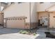 Townhome exterior with tan siding, stone accents, attached garage and landscaped front yard at 12214 Stone Timber Ct, Parker, CO 80134