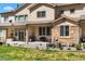 Back exterior of a townhome with stone accents and outdoor seating area at 12214 Stone Timber Ct, Parker, CO 80134