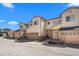 Exterior of townhome with tan siding, stone accents, attached garages and manicured landscaping at 12214 Stone Timber Ct, Parker, CO 80134