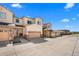 Exterior of townhome with tan siding, stone accents, attached garages and manicured landscaping at 12214 Stone Timber Ct, Parker, CO 80134