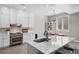 Bright kitchen with white cabinets, stainless steel appliances, and an adjacent dining area at 12214 Stone Timber Ct, Parker, CO 80134